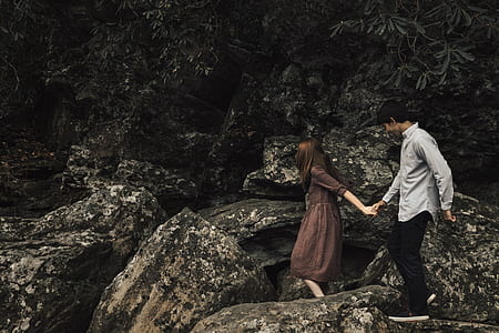 woman and man holding hands during daytime thumbnail