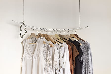 hanged assorted-color clothes beside white paint wall room thumbnail