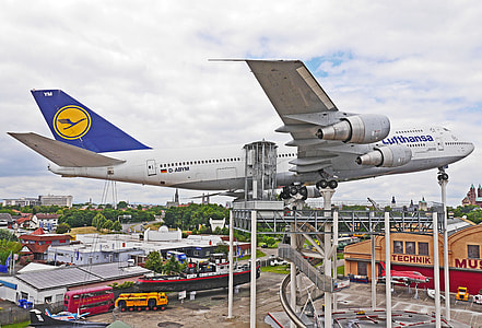 photo of white airplane under white clouds at daytime thumbnail