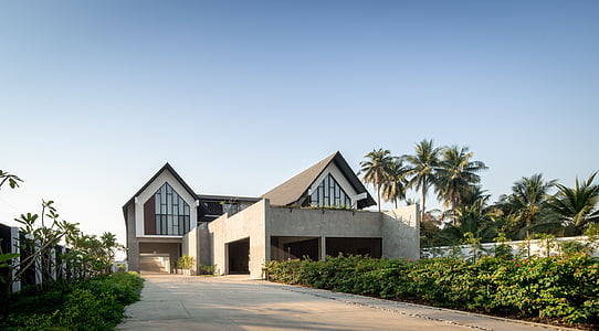 gray and white concrete house near trees thumbnail