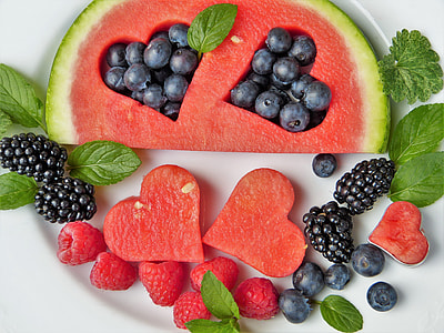 slice melon with grapes and strawberry on white ceramic plate thumbnail