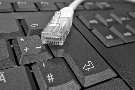 white ethernet cable on black computer keyboard thumbnail