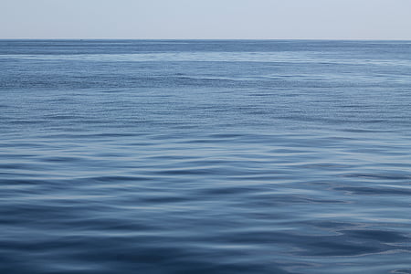blue body of water under blue sky at daytime thumbnail