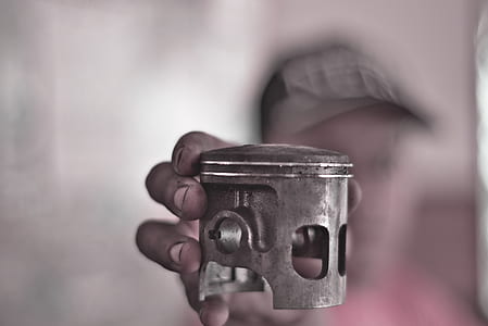 person holding motorcycle piston thumbnail