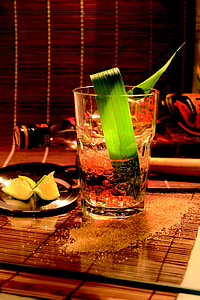 clear drinking glass beside black ceramic saucer on brown surface thumbnail