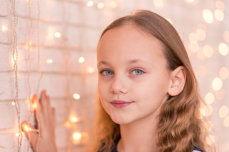 girl holding wall with string lights thumbnail