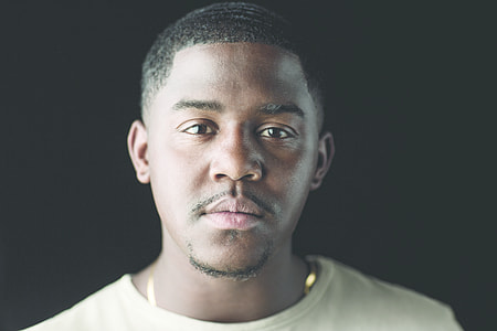 man wearing white crew neck shirt and gold link necklace thumbnail