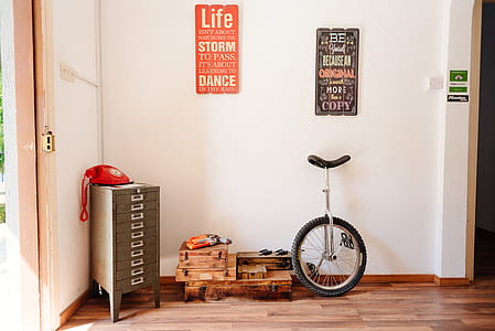 black and silver unicycle on wooden floor thumbnail