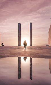 man standing near pillars thumbnail