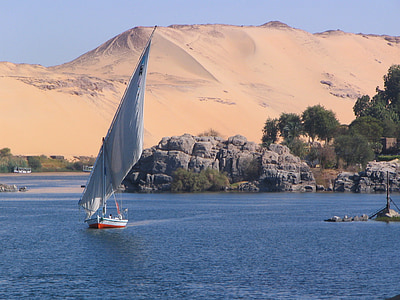 white sailboat near desert at daytime thumbnail