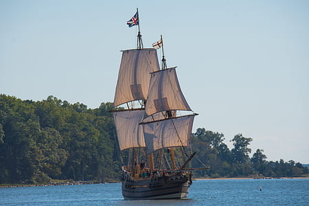 brown ship on calm water during daytime thumbnail