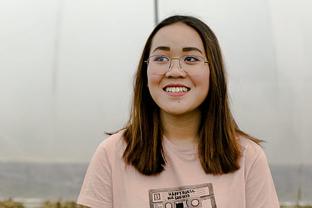 smiling woman in pink crew-neck shirt posing for photo thumbnail
