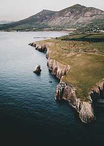 birds eye view of body of water and cliff thumbnail