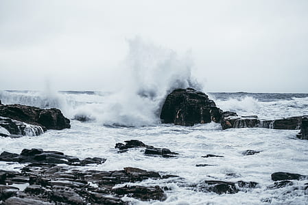 splashing sea water on seashore at daytime thumbnail