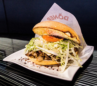 Doner burger placed on square white ceramic platter thumbnail