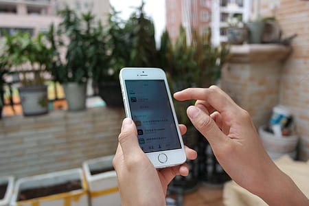 person using silver iPhone 5s thumbnail