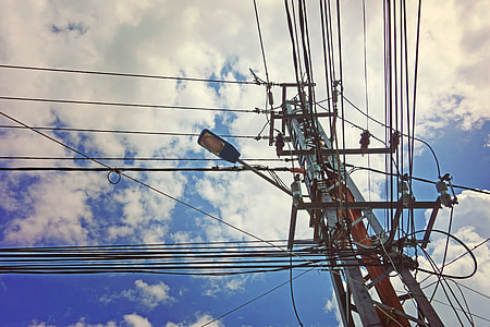 low angle view of cable post under blue and white sky thumbnail