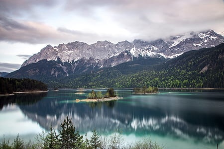body of water surrounded by mountains thumbnail