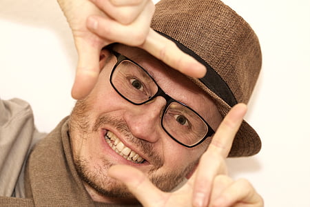 smiling man taking selfie thumbnail