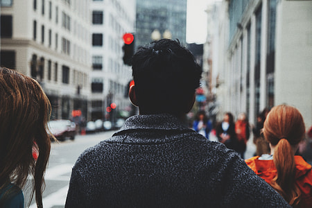 shallow focus photography of man walking on streets thumbnail