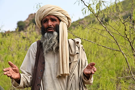 man wearing white robe near tree standing thumbnail