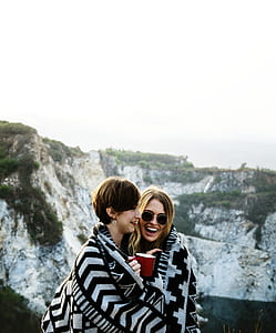 two woman sharing blankets at terrace thumbnail
