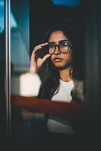 woman holding her eyeglasses thumbnail