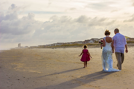 man and woman walking on the beach sands thumbnail