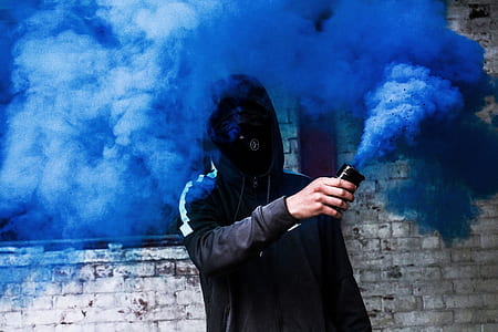 person holding blue smoke fragment thumbnail