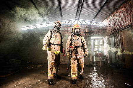 two firefighters near door during daytime thumbnail