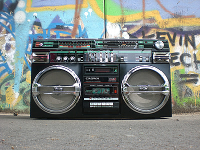 photo of black Crown boombox near graffiti painted wall thumbnail