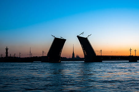 silhouette of concrete building on body of water thumbnail