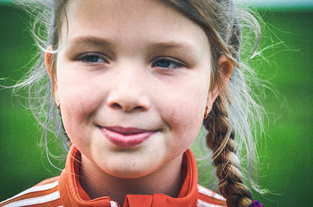 closeup photography of girl wearing orange and white jacket thumbnail