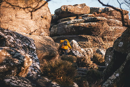 man climbing rocks at daytime thumbnail