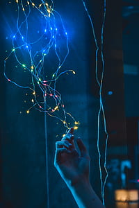 person touching string lights thumbnail