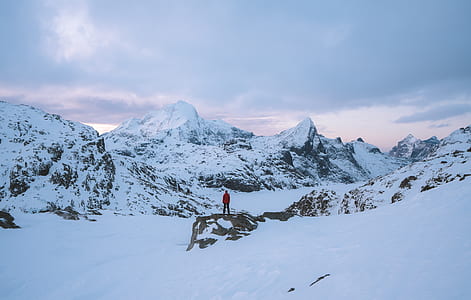 person standing on snow-capped mountain thumbnail