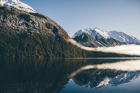 mountains and body of water during daytime thumbnail