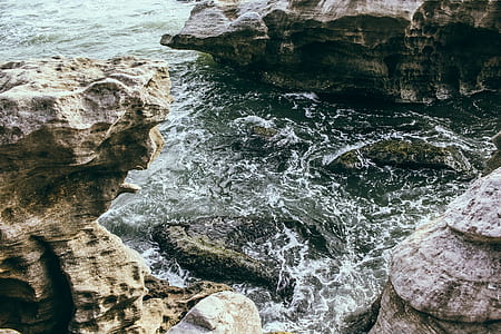 Brown Rock Formation Near Body of Water thumbnail