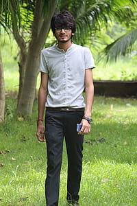 man in white t-shirt standing on grass thumbnail