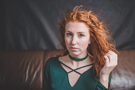 brown-haired woman in green top shallow focus photography thumbnail