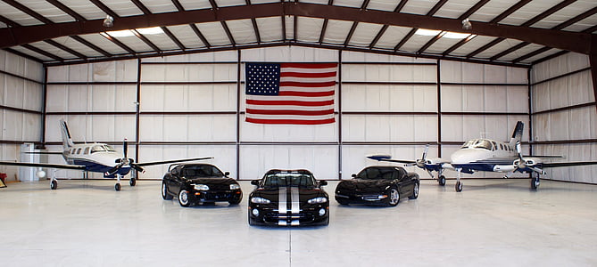 photo of three black vehicles and two white planes thumbnail