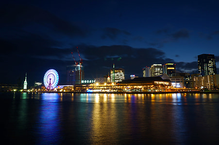ferris wheel beside body of water during nighttime thumbnail