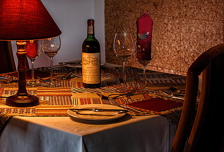 wine bottle, wine glasses and table lamp on square table thumbnail