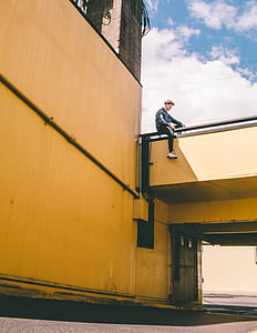 man sitting on railing thumbnail