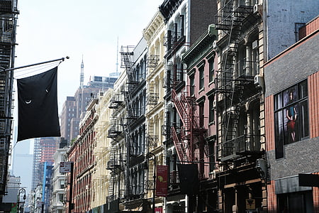 low angle photo of assorted-color painted city high rise buildings during daytimes thumbnail