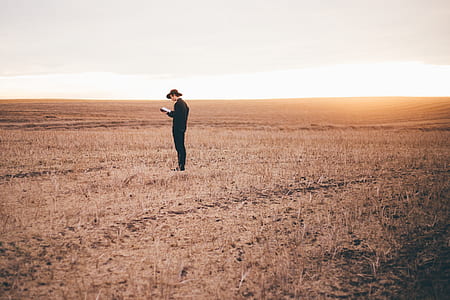 person standing on grass field thumbnail