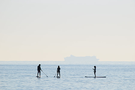 landscape photography of three person on boats thumbnail