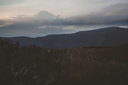 silhouette photo of mountains under white skies thumbnail
