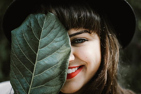 shallow photography of woman holding leaf thumbnail