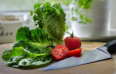 tomato and green leafy vegetable beside black handled knife thumbnail